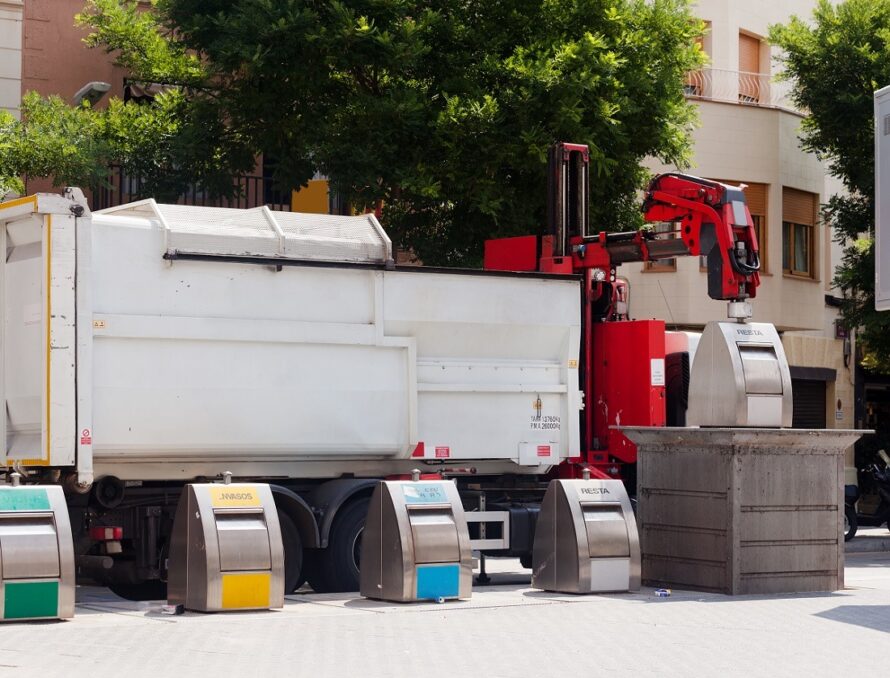 Recycling truck picking up bin at city