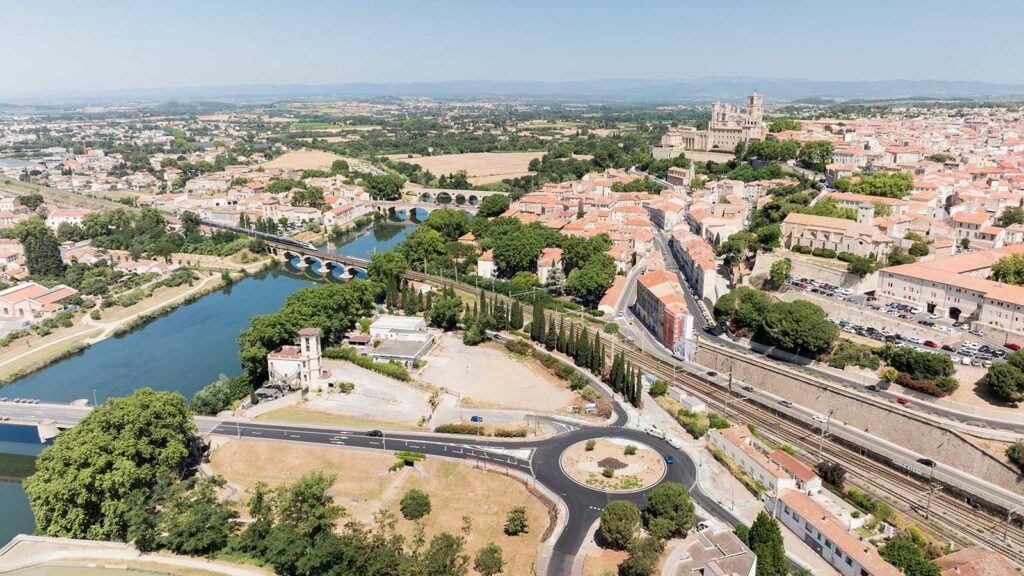 Vue aérienne de Béziers avec la rivière Orb, ses ponts historiques et la cathédrale Saint-Nazaire dominant la ville